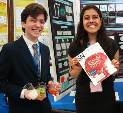 Benjamin Feinstein and Claire Sukumar holding pieces of their WESEF displays. Feinstein's research placed him as a finalist in the MIT INSPIRE competition, while Sukumar's led to placement at the state level of JSHS. Both students were semifinalists in the Intel STS competition earlier this year.